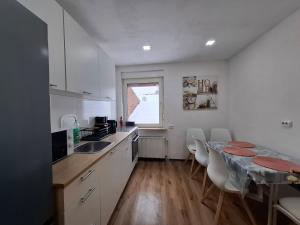 a kitchen with a table and a counter top at Ferienhaus Werratalsee in Frieda