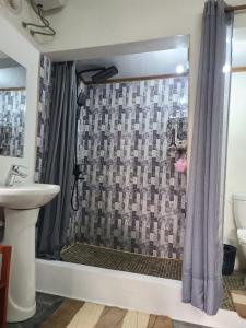 a bathroom with a shower with a sink at Seromue in Antsiranana +25 photos