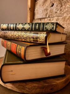 a stack of books sitting on top of a table at Refuge Éclatant Paray 4 couchages in Paray-le-Monial