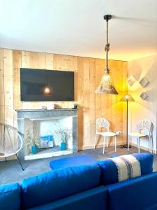 a living room with a blue couch and a fireplace at Le Gouvernail - Montélimar in Montélimar