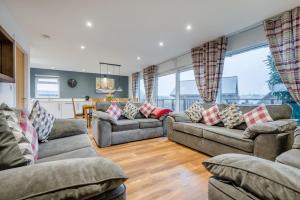a living room with two couches and a dining room at 4 Bed in Winnards Perch oc-w34023 in Saint Columb Major