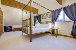 a bedroom with a canopy bed and a glass table at 4 Bed in Winnards Perch oc-w34023 in Saint Columb Major +36 photos