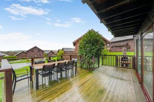 a deck with chairs and tables on a house at 4 Bed in Winnards Perch oc-w34023 in Saint Columb Major