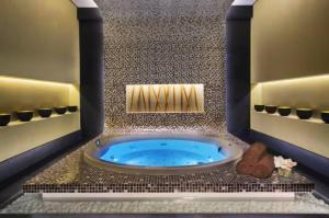 a bathroom with a blue tub in a room at Vogue Vacation Homes, Business Bay Damac Cour Jardin close to Downtown, Burj Khalifa and Dubai Mall, Studio Apartment with City View, Access to all Amenities in Dubai