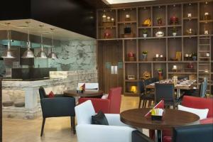 a restaurant with tables and chairs and a bar at Vogue Vacation Homes, Business Bay Damac Cour Jardin close to Downtown, Burj Khalifa and Dubai Mall, Studio Apartment with City View, Access to all Amenities in Dubai +24 photos