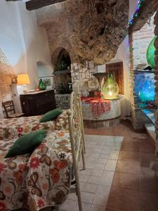 a bedroom with a bed and a stone wall at AL CANTINONE in Toffia