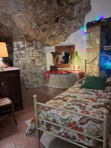 a bedroom with a bed and a stone wall at AL CANTINONE in Toffia +22 photos