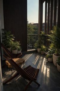 a balcony with a chair and potted plants on it at 19 home in Hue