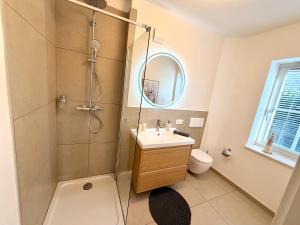 a bathroom with a sink and a shower at Ferienhaus 1 Fuchsweg in Stralsund +9 photos