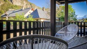 two white chairs and a table on a porch at Chezgege in Valloire