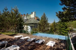 a house with a swimming pool on a deck at Курортний комплекс Santa Maria in Skhidnitsa