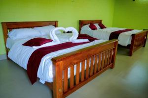two beds with swans on them in a bedroom at Aqua Terra Villas in Belūr