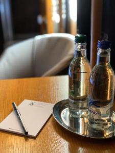 two bottles of water on a plate on a table at The Dutch Mill Hotel in Aberdeen