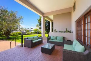 a patio with two couches and a coffee table at Cumberland Hotel & Conference Centre Worcester in Worcester
