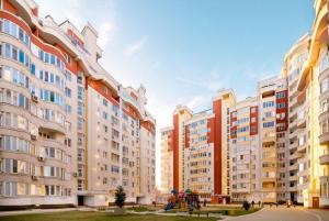 a group of tall buildings with a playground in front at Apartment Lev Tolstoi in Chişinău