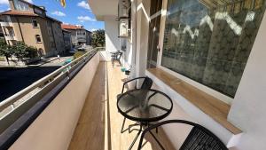 a bike sitting on a balcony with a view of a street at Apartment ADELINA in Tsarevo