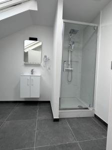 a white bathroom with a shower and a mirror at Hotel Albert in Brussels +70 photos