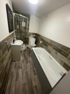 a bathroom with a tub and a toilet and a sink at The Riverside inn in Saltford +75 photos