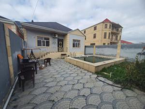 a house with a patio with a pool in it at dlb VILLA 2 in Baku
