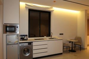 a kitchen with a sink and a dishwasher at Albateel 2 Serviced Apartments-اقتصادي in Riyadh