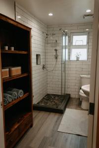 a bathroom with a shower and a toilet and a sink at Quadra Island Mist in Quathiaski Cove
