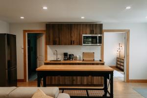 a kitchen with a island in a living room at Quadra Island Mist in Quathiaski Cove