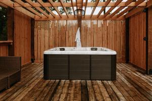 a bathroom with a bath tub in a wooden room at Quadra Island Mist in Quathiaski Cove +16 photos