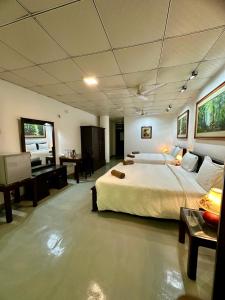 a large bedroom with a large bed and a desk at Paragon mirissa by REO in Mirissa