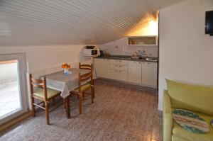 a kitchen and dining room with a table and chairs at GALANT apartments in Rovinj +28 photos