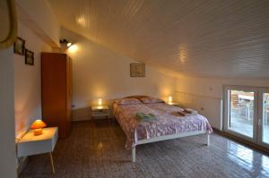 a bedroom with a large bed and a window at GALANT apartments in Rovinj