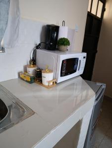 a microwave sitting on top of a kitchen counter at FloJoy Haven Machakos in Machakos