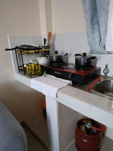 a kitchen with a stove with pots and pans on it at FloJoy Haven Machakos in Machakos