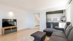a living room with a couch and a flat screen tv at Villa Julija by Villas Guide in Smokvica