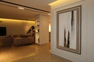 a living room with a painting on the wall at Albateel 2 Serviced Apartments-اقتصادي in Riyadh