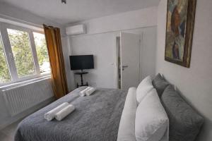 a bedroom with a bed with two white pillows on it at Boheme Studio in Timişoara