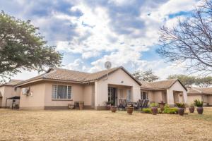 a house with a large yard in front of it at Carousel Eco Estate in Temba