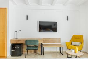 a room with two chairs and a table and a tv at Hotel L'Anxana - Sólo Adultos in Formiche Alto +30 photos