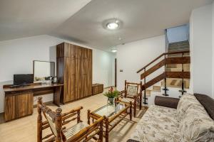 a living room with a couch and a table at Ema Hotel Bansko in Bansko