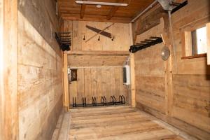 a room with a wooden wall with a clock on it at Apartments Kressl in Gosau