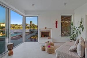 a living room with a couch and a fireplace at Annassa Experience Villa 2' walk from Almyrida beach in Almyrida