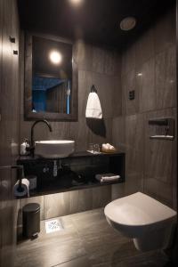 a bathroom with a white toilet and a sink at Arctic TreeHouse Hotel in Rovaniemi +50 photos