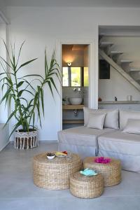 a living room with a couch and two ottoman at Annassa Experience Villa 2' walk from Almyrida beach in Almyrida +73 photos
