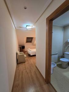 a room with a bathroom with a toilet and a sink at HOTEL EL ROBLE PALENTINO in Cervera de Pisuerga +165 photos