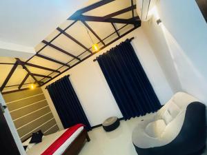 a room with a bed and a couch and a chair at Woori House in Kamburugamuwa +17 photos