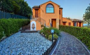 a house with a stone path in front of a house at La casa di Carla in Fermo