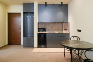 a kitchen with a table and a counter top at LALO Hotel Abastumani in Abastumani
