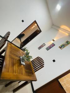 a living room with a bench and a mirror at Woori House in Kamburugamuwa