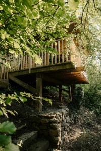 a wooden deck sitting on top of a stone wall at Kestrel lodge in Wrexham