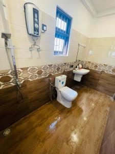 a bathroom with a toilet and a sink at Woori House in Kamburugamuwa