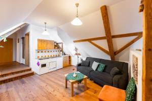 a living room with a couch and a table at Buchgrabenhof in Windisch Minihof